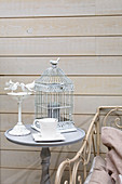 Bird-cage lamp on side wall against board wall
