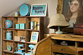 Collection of vintage cans in shades of blue on wooden shelves