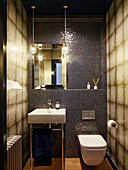Toilet and various tiled in shades of brown in small bathroom