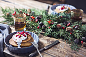 Christmas breakfast table: pumpkin pancakes with yogurt cream and currant