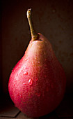 A red pear on a black background (close up)