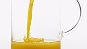 Orange juice in jug, slow motion