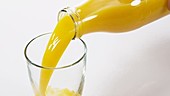 Orange juice in glass, slow motion