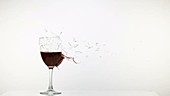 Glass of wine exploding, slow motion