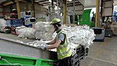 Man sorting plastic on conveyor belt