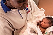 Hospital nurse with newborn baby