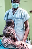 Surgeon with child awaiting surgery
