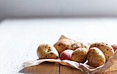 Various potatoes on a piece of paper