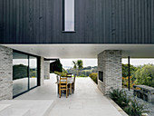 Dining set on roofed terrace of architect-designed house