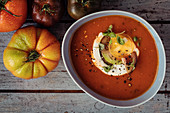 Tomato soup with heritage heirloom tomatoes, cream, baby basil, cracked black pepper and garlic and rustic bread