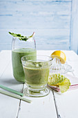 A peach and spinach smoothie, and an orange and savoy cabbage smoothie