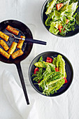 Herb and potato croquettes with a green summer salad