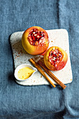A baked apple with almonds and berry jam