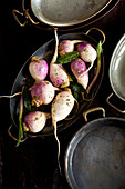 Raw turnips in a roasting pan