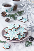 Gingerbread snowflake cookies decorated with royal icing