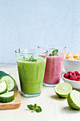 A raspberry and melon smoothie and a green coconut smoothie with rocket