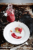 A potato with beetroot ketchup