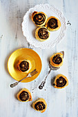 Poppy seed snails on a golden plate with a cake fork