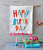 A Happy Birthday banner and colourful presents for a child's birthday