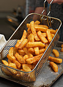 French fries draining in a basket