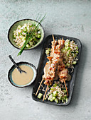 Satay skewers with a peanut sauce and cucumber rice
