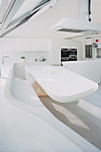 Dining table and curved corner bench in futuristic kitchen-dining room
