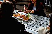 Street food - Women eating chicken tikka masala from polystyrene boxes