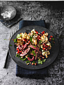 Beef fillet with marinated cauliflower and pomegranate seeds