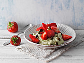 Avocado and cream cheese dessert with strawberries and pistachio nuts