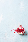 A halved pomegranate on a white surface