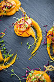 Fried scallops on mashed butternut squash with cress