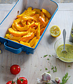 Oven-baked potato wedges in a baking dish