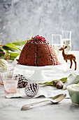 Gluten-free steamed pudding with spiced pomegranate syrup