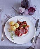 Venison medallions with potato and saffron dumplings and port wine infused shallots