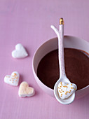 Marshmallow hearts decorated with gold beads, served with hot chocolate