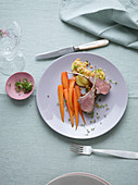 Saddle of lamb with anise and spiced carrots served with a warm potato and lentil salad with cress