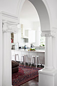 View of counter in kitchen seen through arched doorway