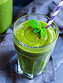 Vegan green smoothie with avocado, kiwi, banana and spinach.