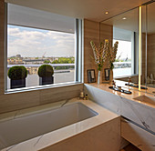 Luxurious bathroom with marble cladding and view of London