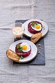 Beetroot tatar with quail eggs, bread crisps and hollandaise sauce