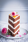 A wedding cake slice decorated with roses
