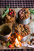 Small plum puddings with a flambé spoon on a cooling rack