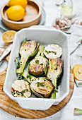 Artichokes with garlic and herbs in a baking dish