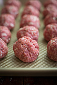 Rows of raw meatballs