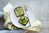 Black bread with avocado, salt and pepper