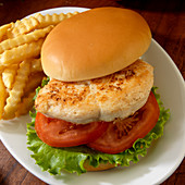 Grilled chicken sandwich with tomato and lettuce with French fried potatoes
