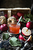 Cousinot apple jelly in a jar, with fresh apples and vegan bagels