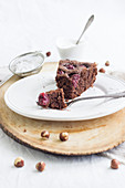 A slice of quick chocolate cherry cake with hazelnuts