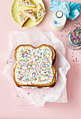A fairy bread cake with buttercream and sugar sprinkles