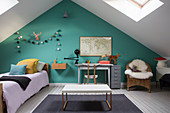 Child's attic bedroom with turquoise wall